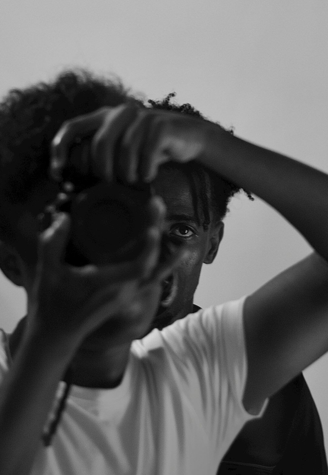 Studio portrait of a Black woman camera operator smiling