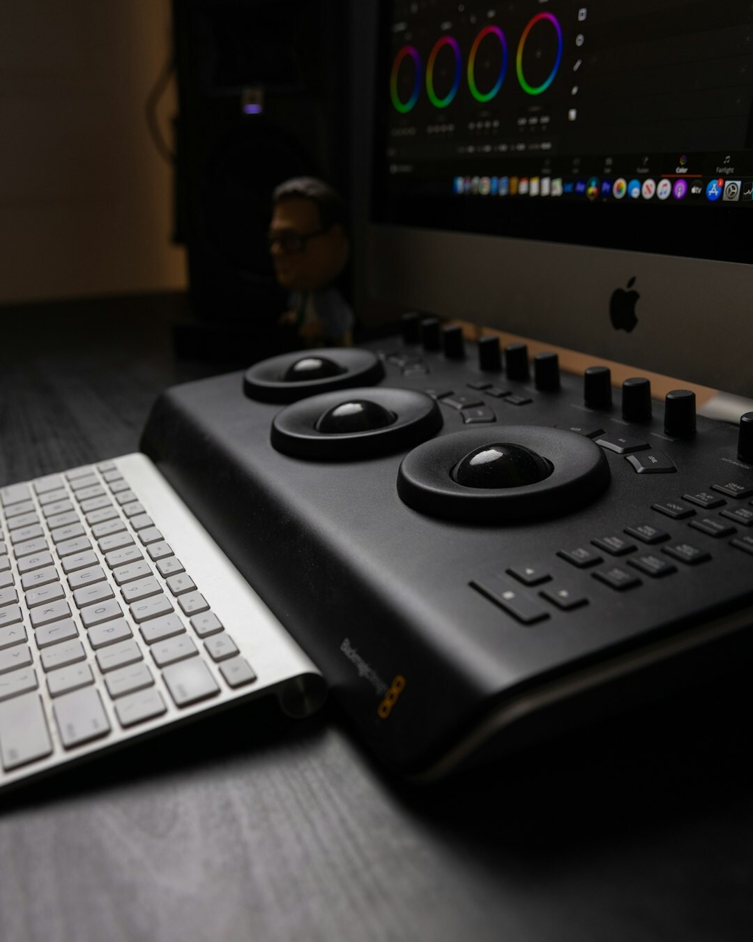 Video editor working at a post-production suite with colour grading monitors